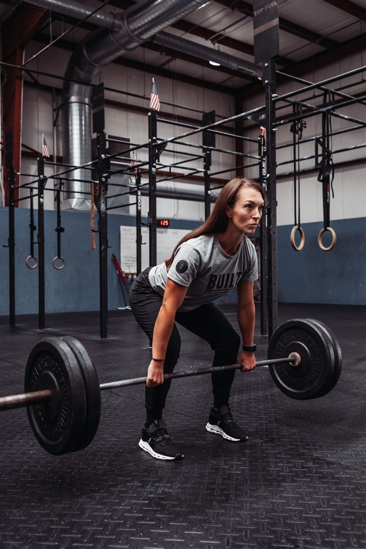 athlete in a gym-based PT setting working with a physical therapist