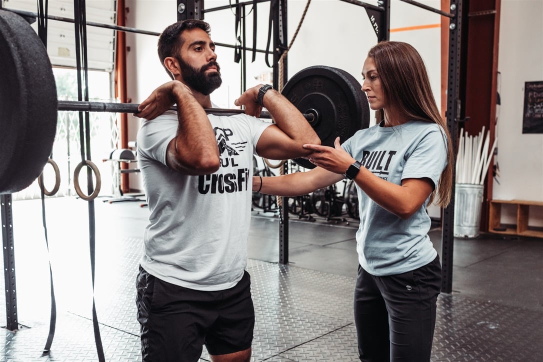 Physical therapist assisting a patient with a sports rehabilitation assessment
